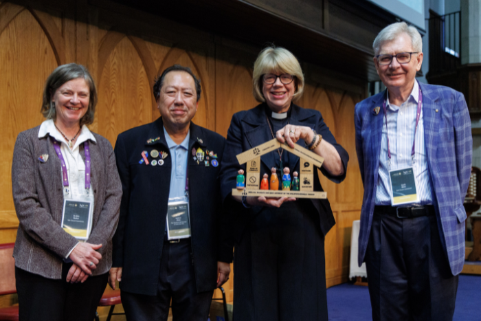 Garth Blake, Canon Andrew Khoo and Dr Kim Barker present a tool symbolising the importance of safe church during a session at ACC-19. They stand with the Most Revd and Rt Hon Dame Sarah Mullally DBE, Archbishop of Canterbury, at the end of the Global Conversation on Safe Church.